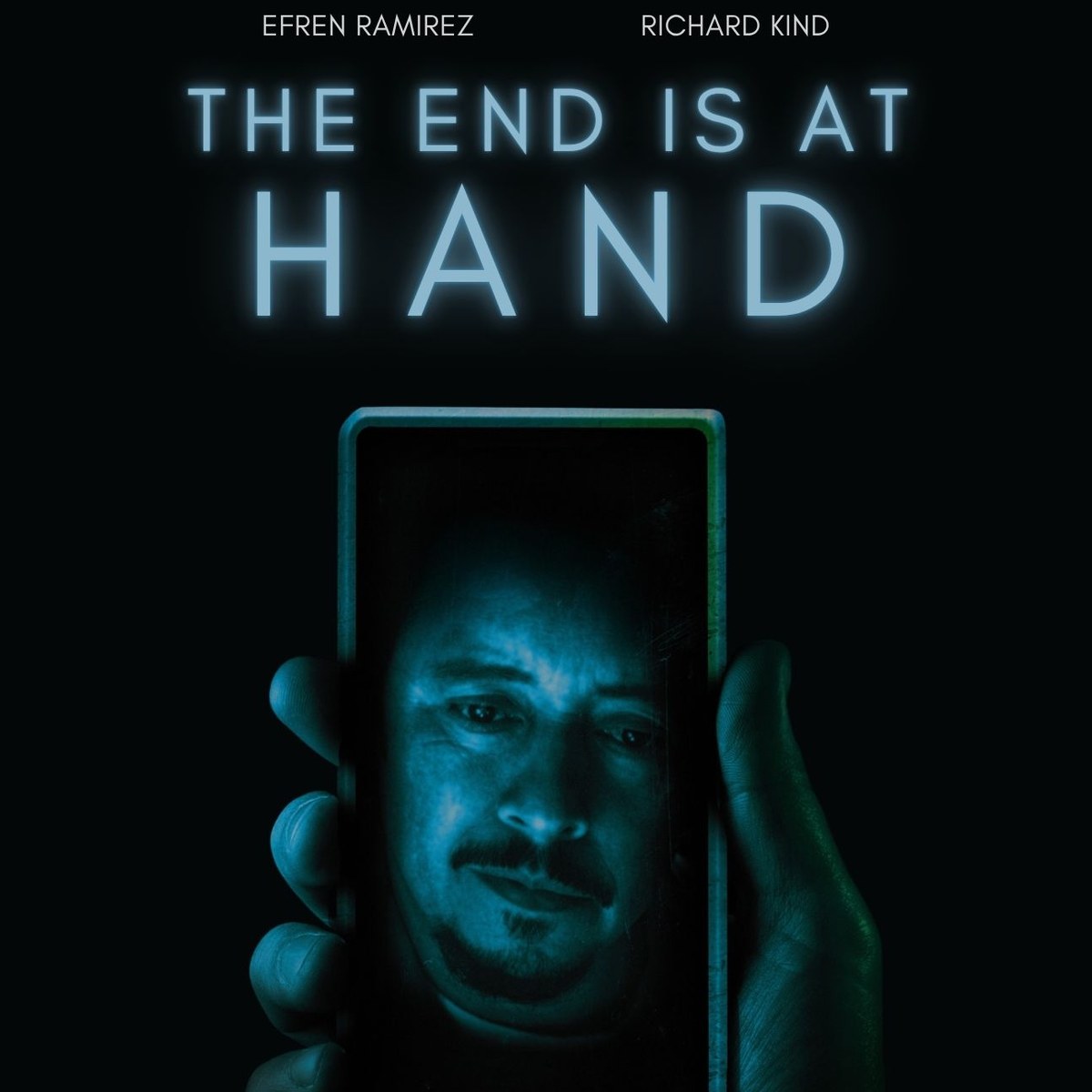 The End Is at Hand — horror short film key art: a hand holding a phone with a face glowing on the screen.